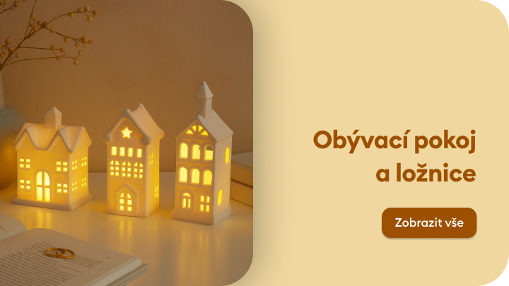 Dekorační osvětlení v podobě keramických domečků, ideální pro obývací pokoj a ložnici. Světlo vytváří útulnou atmosféru, vhodné jako jemné večerní osvětlení. Vedle domečků leží kniha, která naznačuje klidnou chvíli odpočinku. Tlačítko nabízí možnost zobrazit více. banner