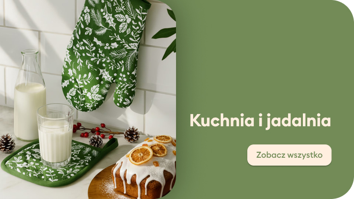 Świąteczna aranżacja kuchni z pieknie ozdobionym ciastem i białym lukrem, szklanką mleka, butelką, dekoracyjnymi szyszkami oraz rękawicą kuchenną w zielone liście. Obok napis "Kuchnia i jadalnia". Przyciski umożliwiają przejście do oferty produktów kuchennych.