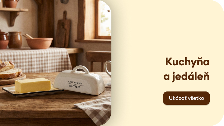 Vidiecka kuchyňa s dreveným stolom a doplnkami. Na stole sa nachádza maslo na tanieriku, prikryté keramickou maselničkou. Atmosféra domáckosti a pohody. Vedľa text „Kuchyňa a jedáleň“ s tlačidlom „Ukázať všetko“.