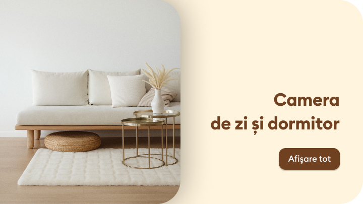 Spațiu modern și confortabil, potrivit pentru relaxare și decorat cu mobilier simplu și elegant. O sufragerie aerisită, cu o atmosferă caldă, care combină funcționalitatea și estetica. În prim-plan, o măsuță joasă cu detalii subtile și o canapea confortabilă.