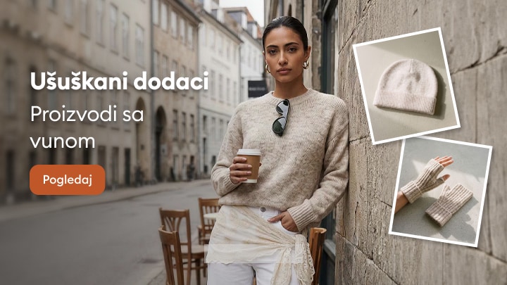 Ženska zimska moda sa vunenim dodacima poput kape i rukavica za hladne dane u gradu