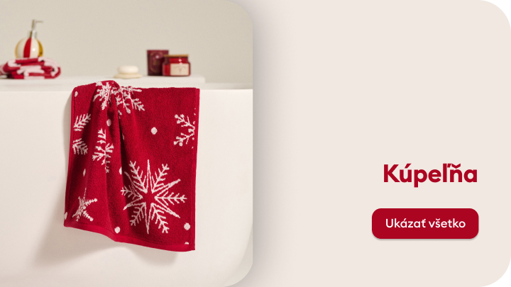 Červený uterák s vianočným motívom zasnežených vločiek zavesený na okraji vane. V pozadí sú drobné kúpeľňové doplnky, ako sú mydlo, dóza a dekorácie. Text na strane informuje o kategórii kúpeľňa s tlačidlom na prezeranie produktov.