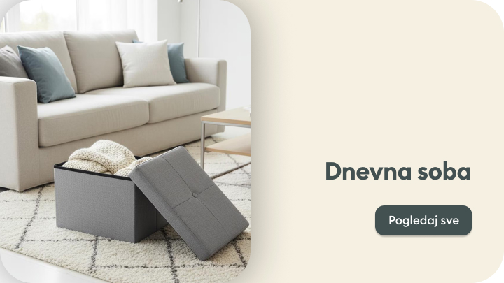 Dnevna soba s udobnim sivim trosjedom, jastucima i stolom. Otvorena kutija s poklopcem služi za odlaganje deka i dodataka. Kliknite na "Pogledaj sve" kako biste pregledali više proizvoda za uređenje dnevnog boravka.
